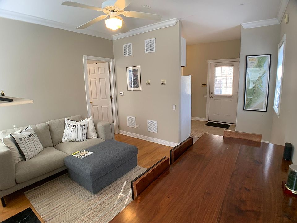 Living Room with hardwood floors and wood-burning fireplace.