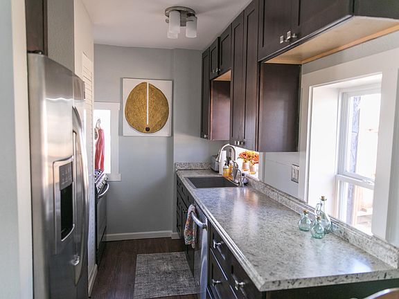 Kitchen has large sink, stove, microwave and dishwasher