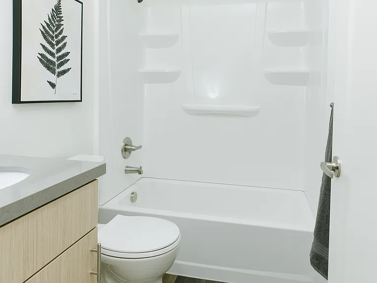 Kids bath has shower/tub and quartz countertop