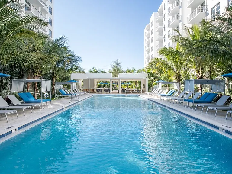 Swimming pool and sundeck with cabanas and lounge seating. Gazebo with flat screen TV.