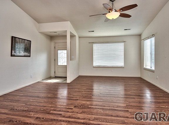 Beautiful, rich-toned hardwood flooring greets you just inside the entry to this