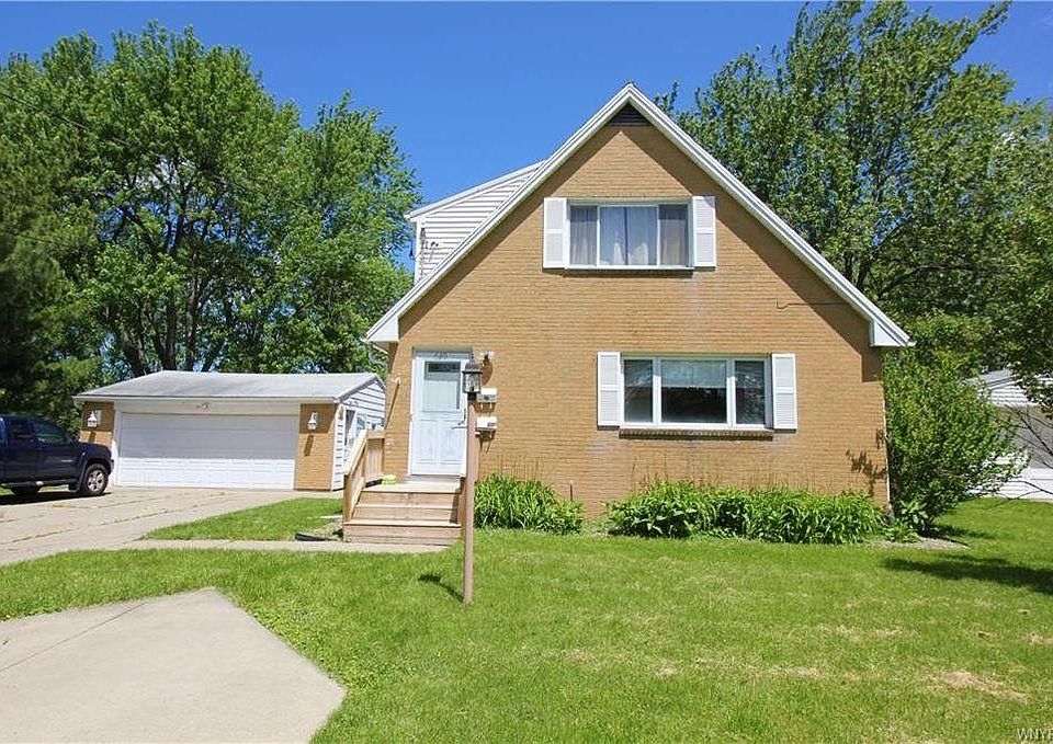 Upper apartment uses front door. Rent includes two parking spaces on cement pad seen in the lower left corner.