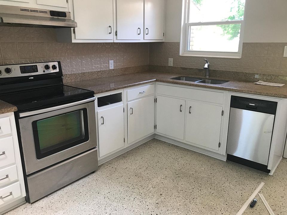 Kitchen with granite countertops and tin backsplash