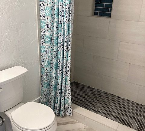 Large tile shower with large granite sink vanity for room to spread out. Once again, new tile flooring, toilet.