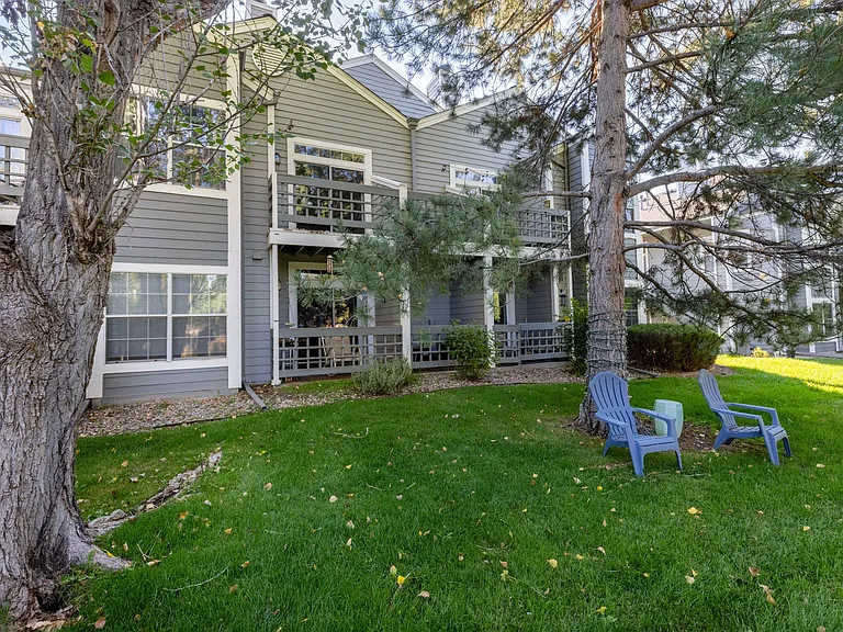 Mature trees and expansive green space create a peaceful neighborhood setting.