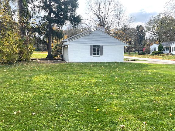 Large side yard with a nicely tree covered back patio