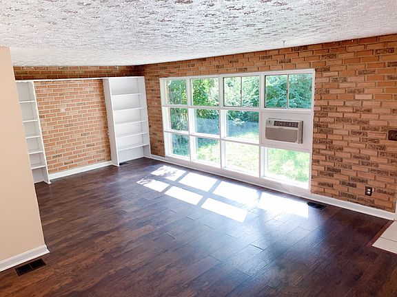 Living room 12X22. With Laminate wood flooring and built in shelving.