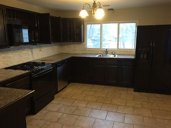 Spacious kitchen, with refridgerator, microwave, range, and
