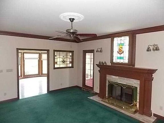 Great Room. Spacious 19 X 15 great room with crown molding & gorgeous cherry & marble double sided fireplace with built in stain glass window. Sunroom can be accessed from this area. Freshly painted interior.
