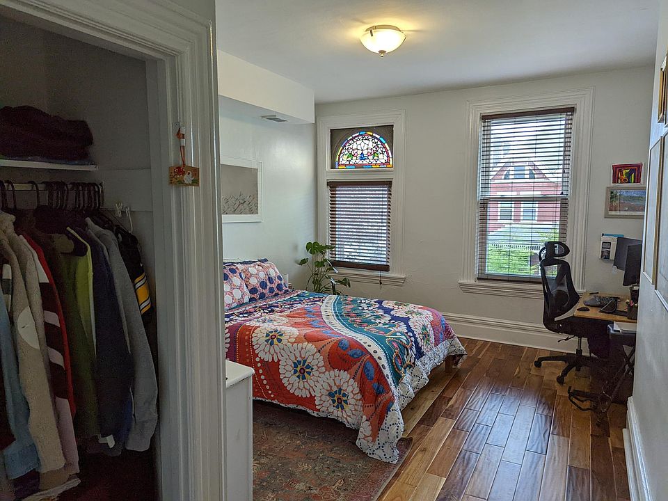 Large master bedroom with original stained glass, and a closet