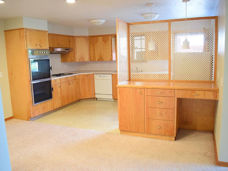 Kitchen and dining area. Loads of cabinets, and a desk area