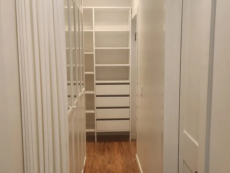 Master bedroom walk-in closet with ceilnig mount curtain
