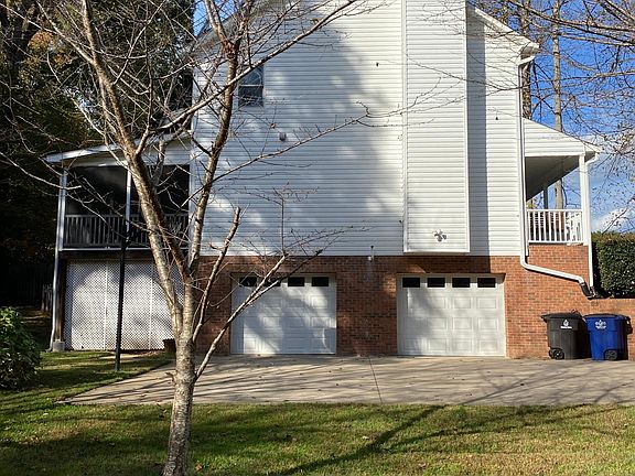 Garage, driveway, basketball hoop. Extra storage under back porch