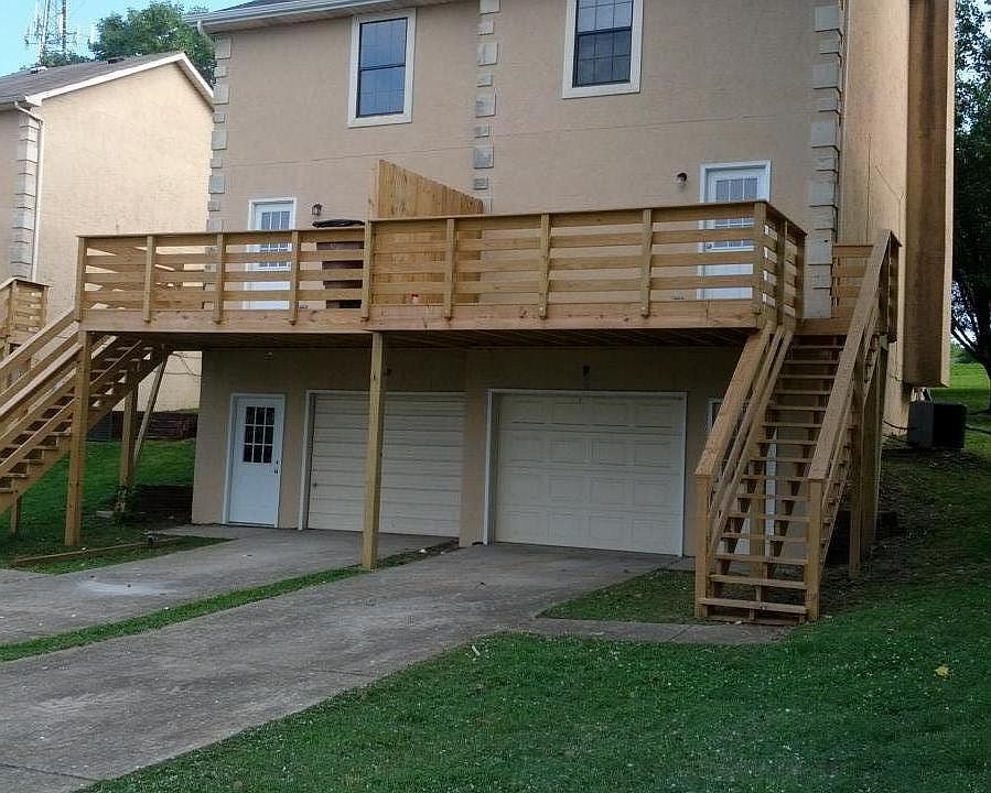 Rear view of property with garage and deck