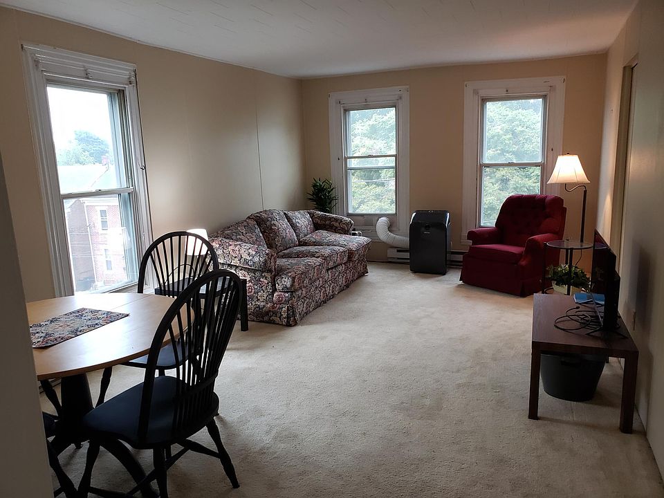 Livingroom/ dining room, side tables and TV (tv - tenant responsibility). White curtains to be added to windows.