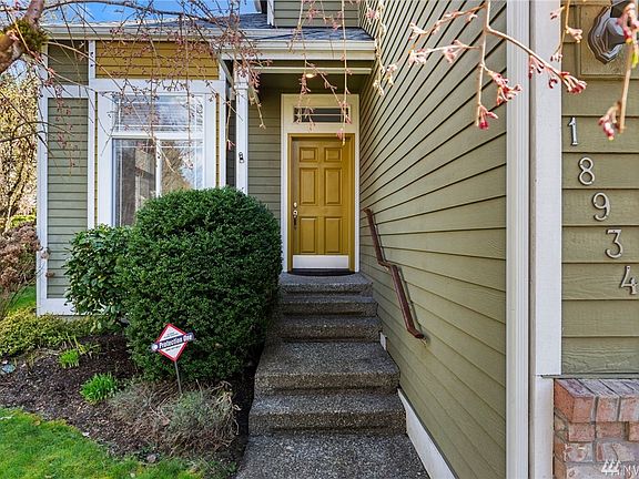 Welcoming entry and yard with mature, low maintenance landscaping.