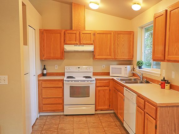 Tons of great storage with lots of cabinets, counter space and a large pantry (seen on left side next to refrigerator). Enjoy views of the Cascade Mountains out the kitchen window.