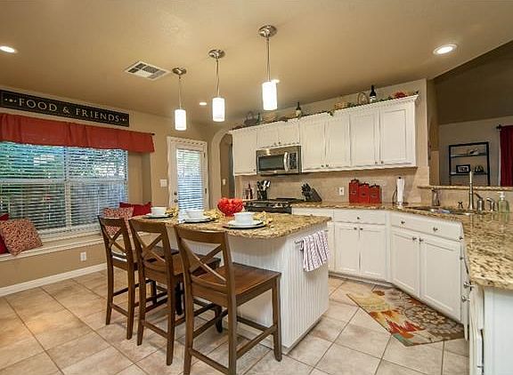Amazing kitchen with recently updated stainless appliances. Check out the granite and the lighting!