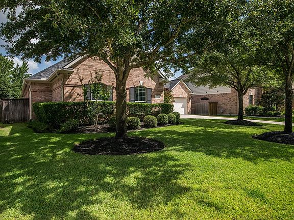 Beautiful landscaping and mature trees surround this stunning one story.