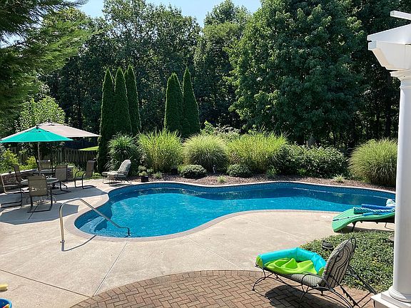 Woods behind fenced yard.