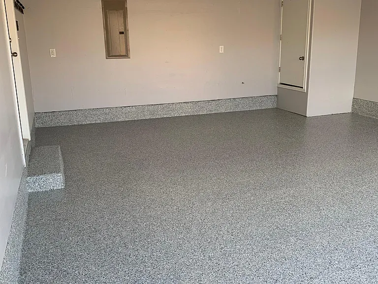 extra storage racks in attached 2 car garage w/ remote control automatic door & resurfaced floor