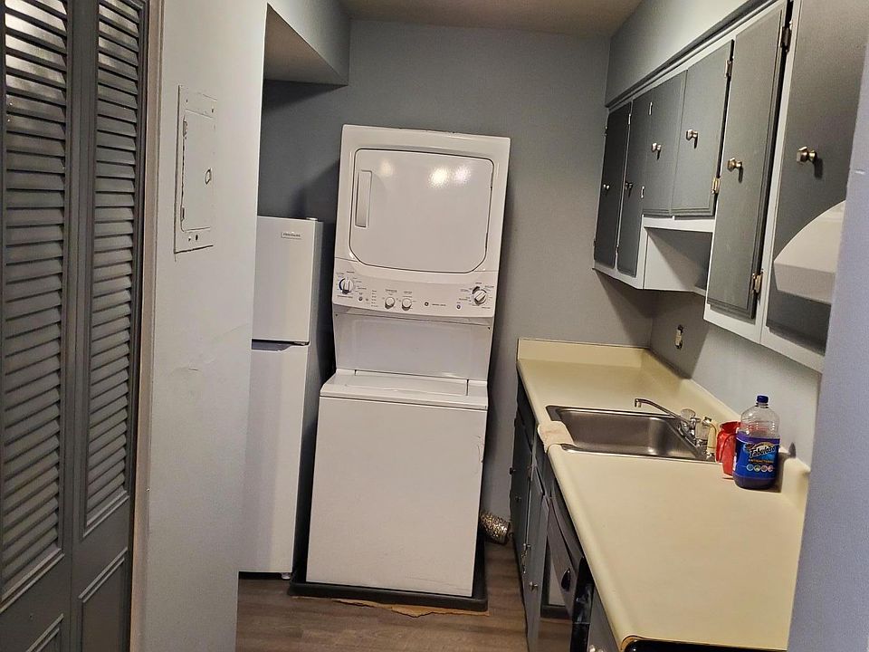 Galley kitchen with washer and dryer