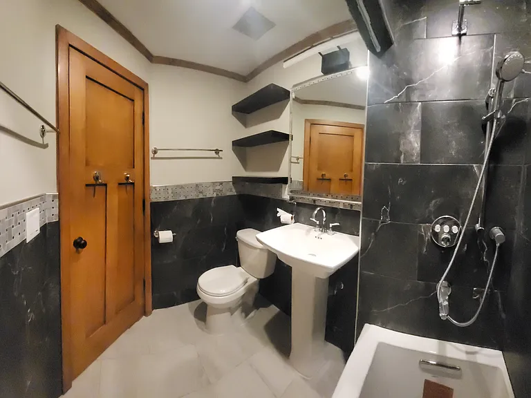 view to bathroom shelves, WC, pedistal sink & bathroom hardware.