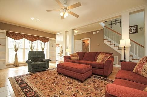 Open Great Room Features Decorative Columns and Built-in Bookcases