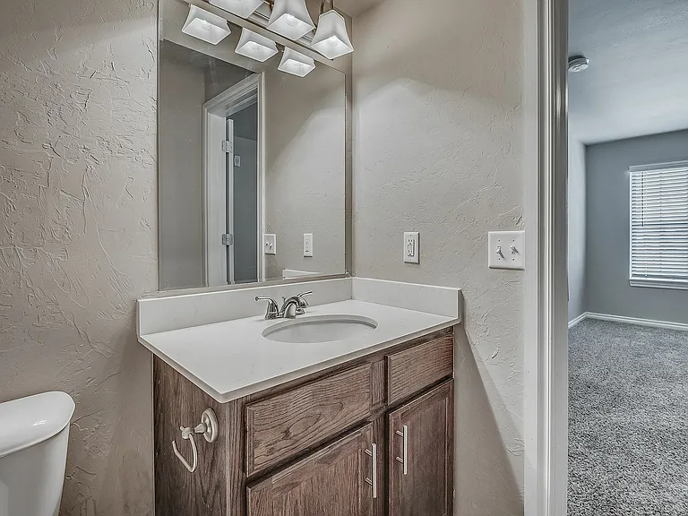 Step into style with a modern bathroom that seamlessly transitions into a sunlit bedroom.