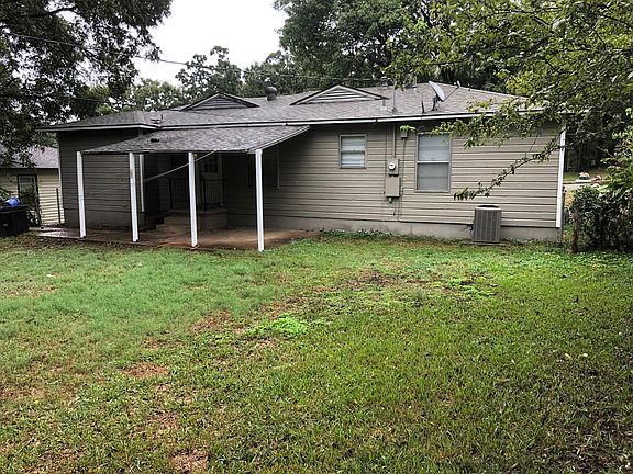 Shady back yard with covered back porch.