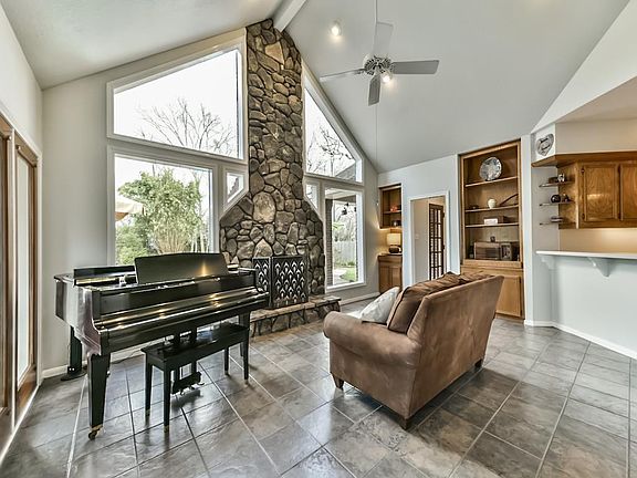 Vaulted ceilings, stone fireplace, and huge windows compliment the Den.