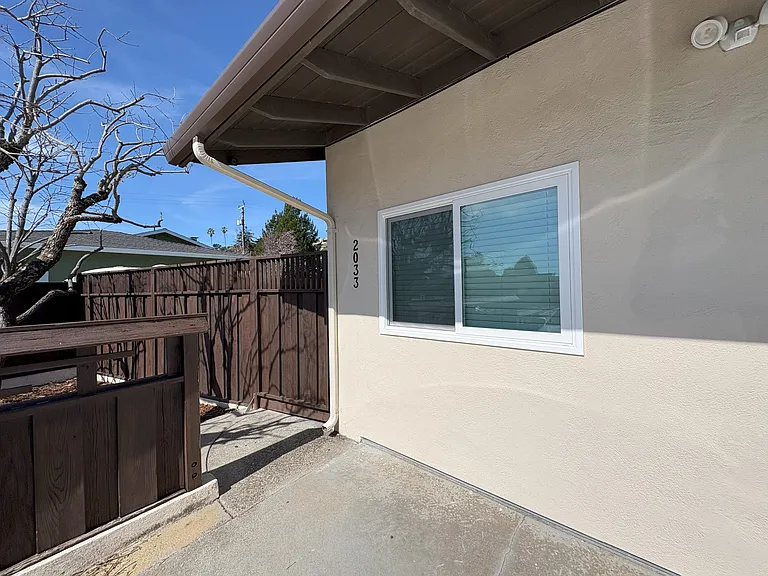 ADU is a converted garage with an entry gate leading to its own yard.