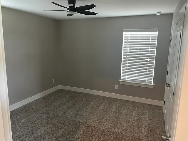 Bedroom 2 upstairs. Carpet and ceiling fan.