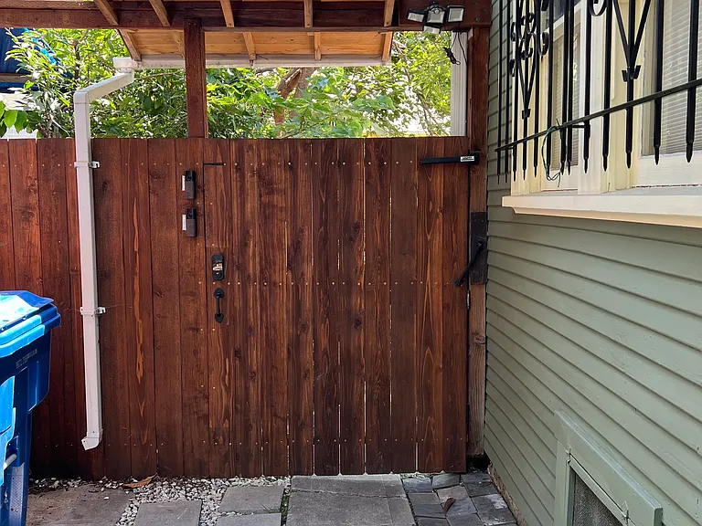 Security gate to backyard and guesthouses