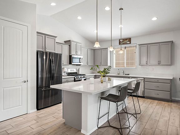 Kitchen is fully stocked with cookware and dinnerware