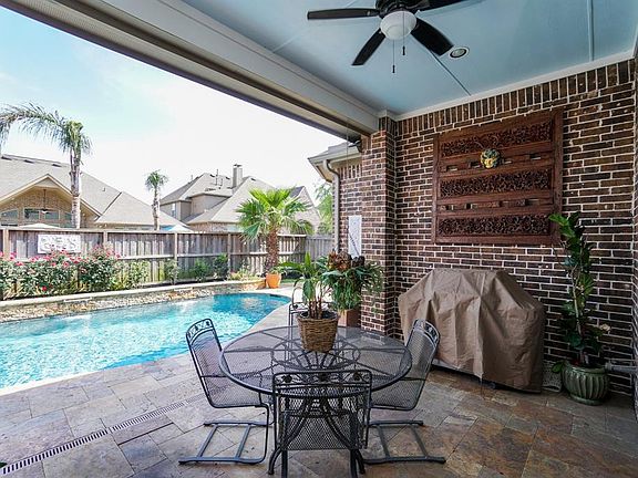 Fabulous outdoor living space. Large covered patio w/recessed lighting, ceiling fan and stubbed for gas and H20. Ready for your outdoor kitchen to be added.