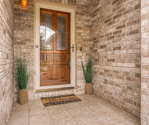 This is the inviting front entrance into the home. Note the versatile storm door.