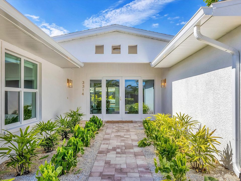 Freshly landscaped front of house and portico with brushed gold finishes