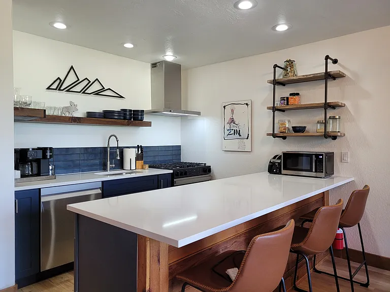 Newly-renovated kitchen with oversize island, new dishwasher, range, fridge