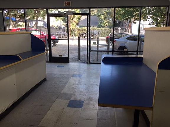 Looking east to the12 car gated parking lot, McCadden Place side.All glass and double glass doors. Inviting.