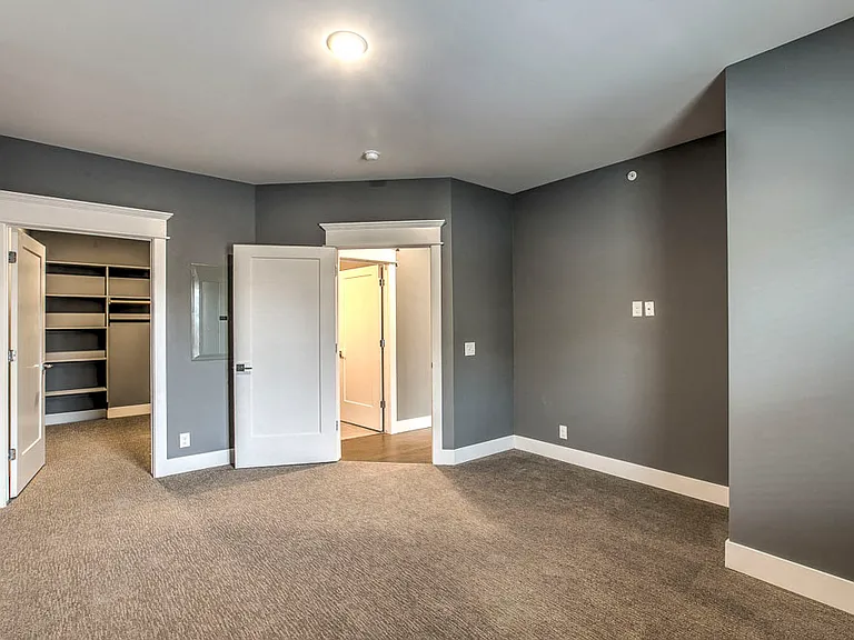 A spacious bedroom with a walk-in closet creates a comfortable, private retreat.