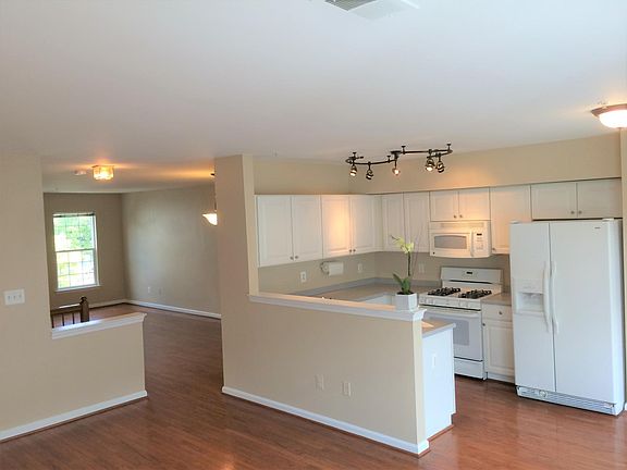 Open and light-filled kitchen, dining room, living room area. Hard wood floors