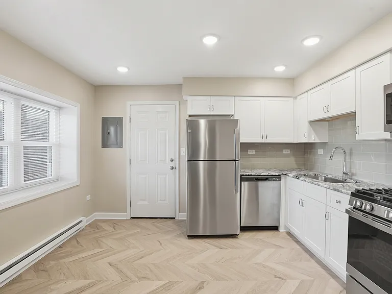 Fully upgraded kitchen with stainless appliances, dishwasher, canned lighting, and deluxe cabinets.