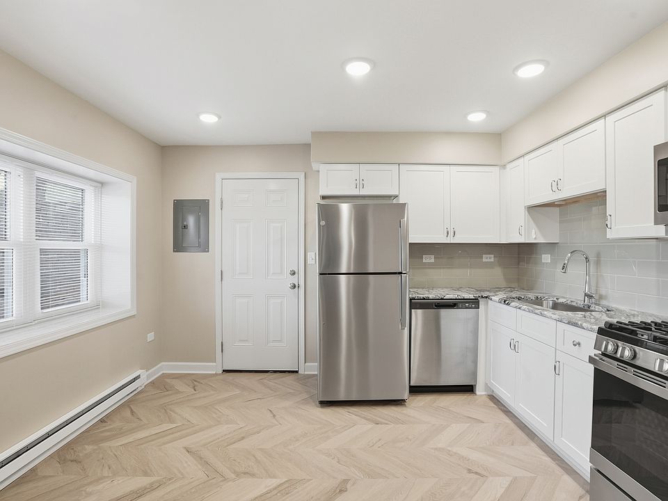 Fully upgraded kitchen with stainless appliances, dishwasher, canned lighting, and deluxe cabinets.