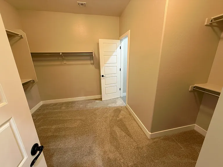 PRIMARY CLOSET WITH PRIVATE ENTRANCE TO LAUNDRY ROOM