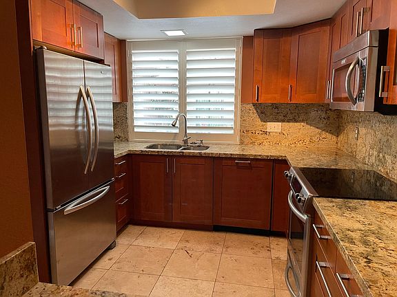Remodeled kitchen with refrigerator and dish washer.