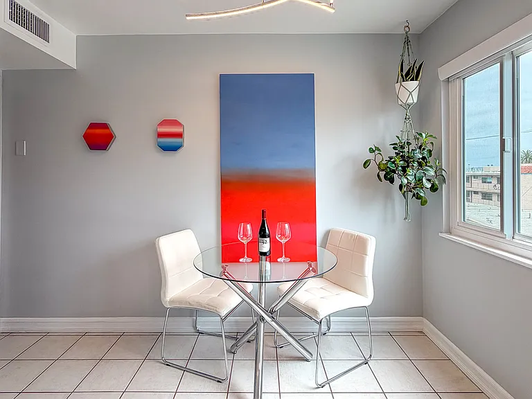 Bright eat-in kitchen with breakfast nook and treetop views