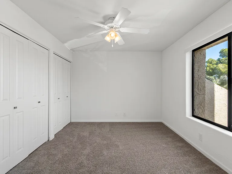 Guest bedroom with Double Closets and Brand New Energy Efficient Tinted Windows. Double doors to the living room make a great Home Office.