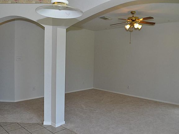 DEN OR FAMILY ROOM IS SET OFF FROM THE KITCHEN BY COLUMNS AND FEATURE HIGH CEILINGS AND GAS LOG FIREPLACE