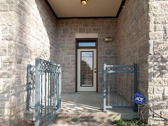 Welcoming covered front porch with a gate.